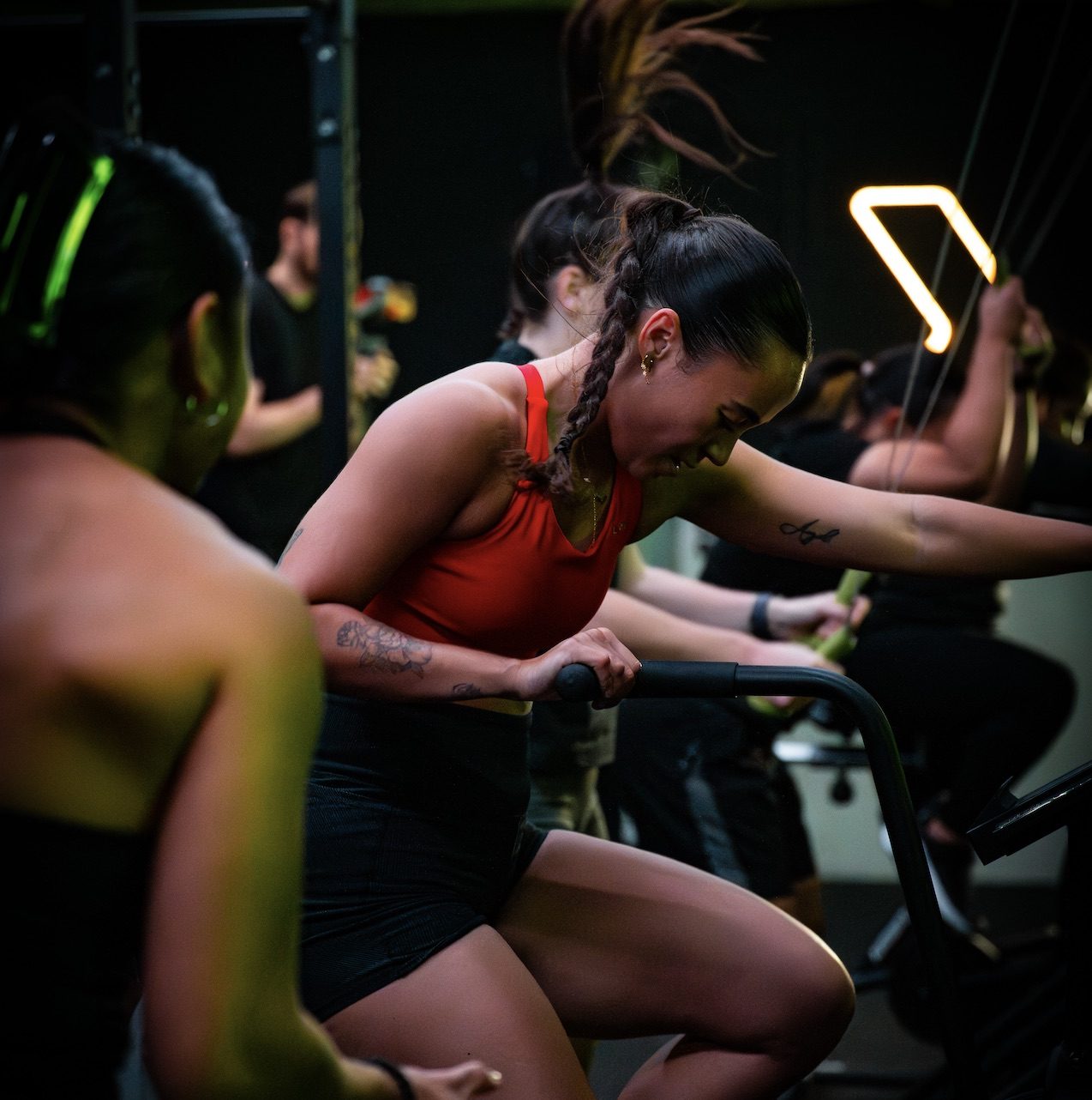 A member pushing hard on the bike during an S30 group session